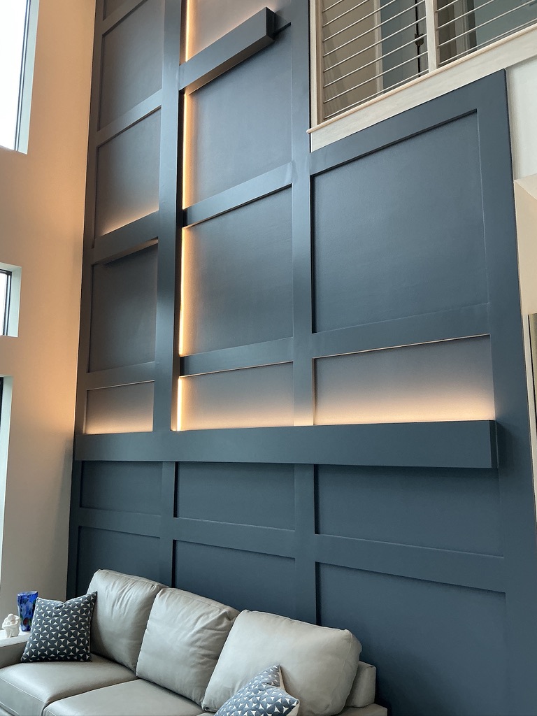 Dramatic feature wall with board and batten and accent lighting